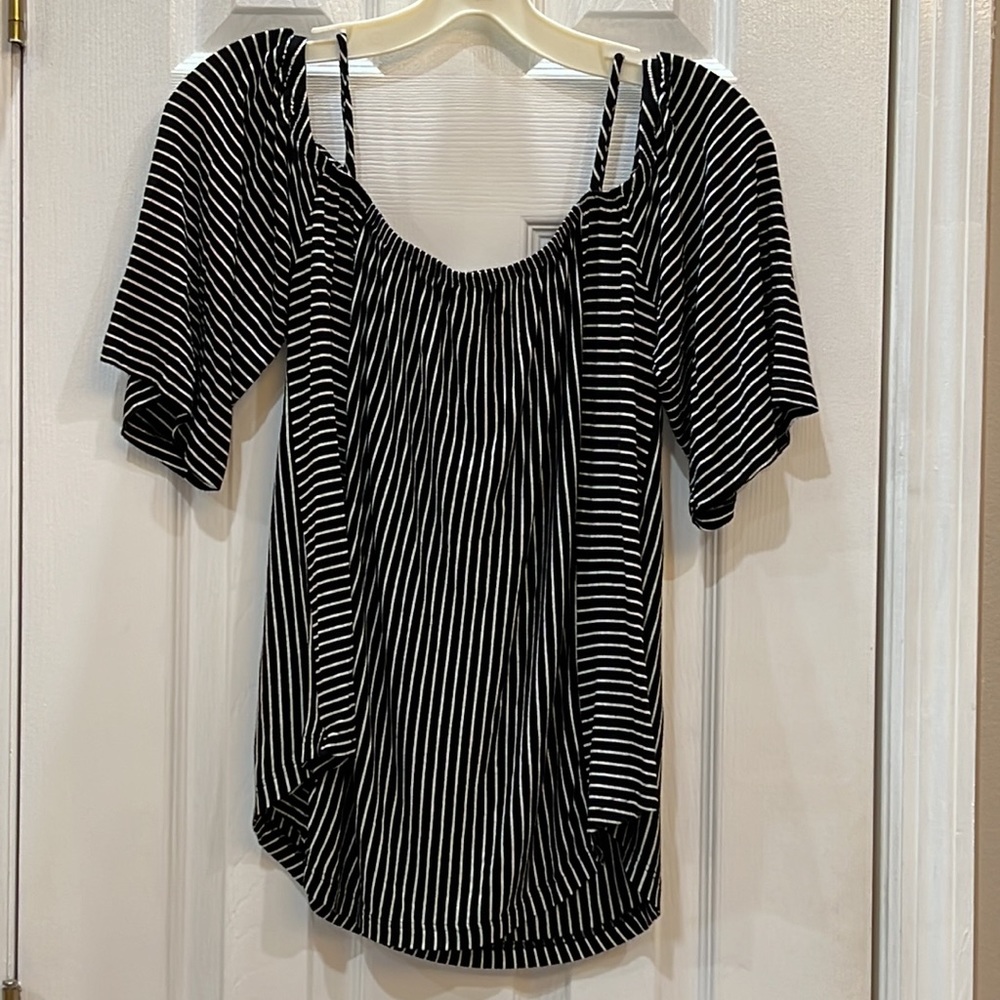 Very cute black and white off shoulder 100% Rayon. Soft and comfortable top.